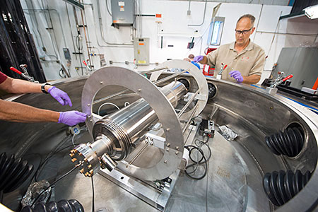 Lab staff working on a cryomodule